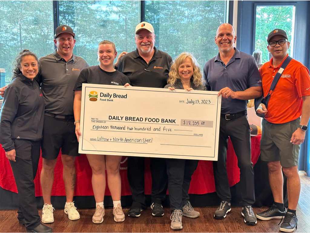 NAS, Liftow and Daily Bread representatives holding large cheque of $18,205 at charity golf tournament in support of Daily Bread Food Bank