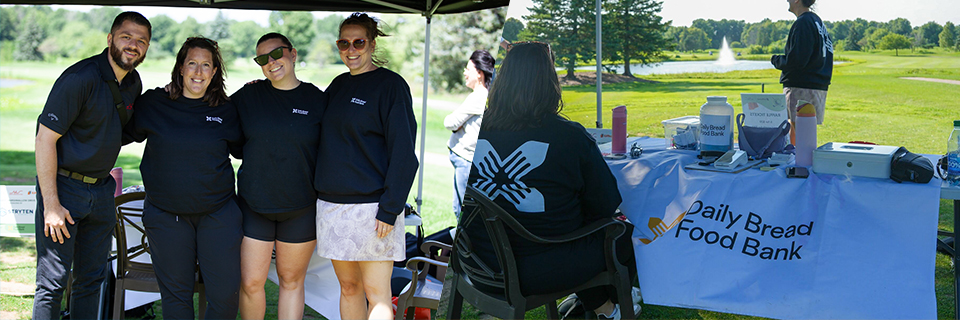 Volunteers smiling and posing together at the golf tournament.