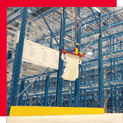 Installed pallet racking system featuring a mounted fire hose and posted compliance signage, highlighting fire protection and regulatory considerations in warehouse design.
