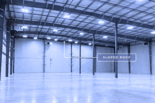 Empty warehouse before standardized pallet racking installation, showing a clear view of the sloped roof challenge.